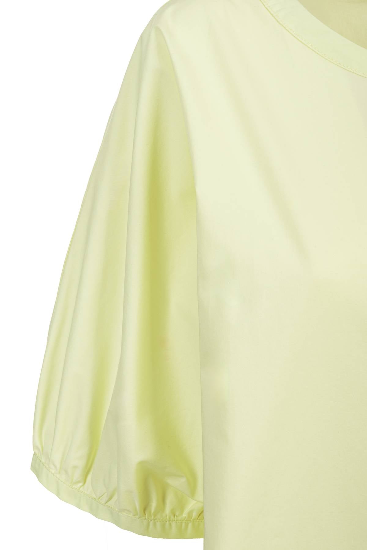 Abito in popeline di cotone con maniche a sbuffo. Look minimalista, taglio moderno, la cerniera davanti termina nel girocollo; cucitura centrale.